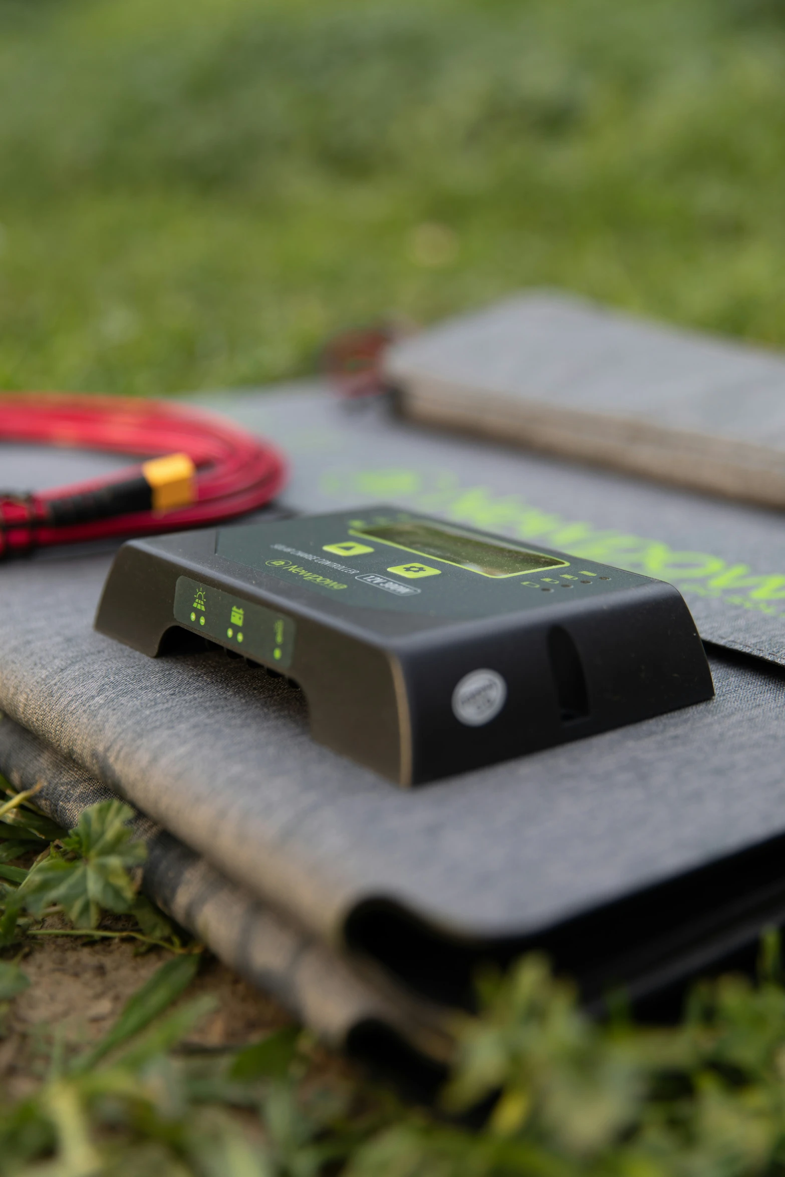 an electronic device resting on a mat in the grass