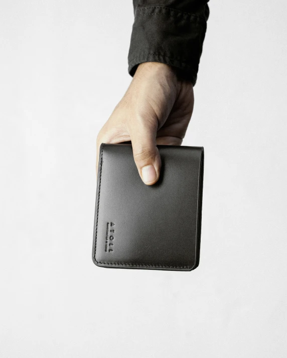 a person is holding an empty leather wallet