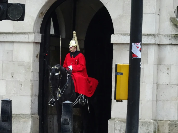 the man in the red cloak is on his horse