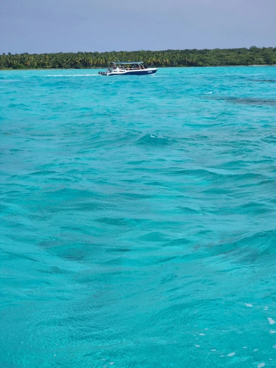 a boat is in the water near a shore line