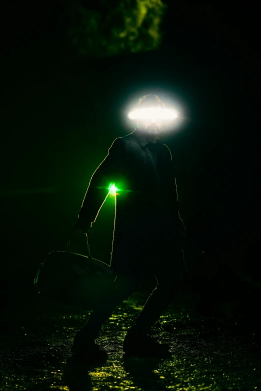 man with a surfboard at night on the beach