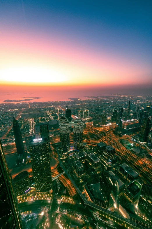 a cityscape is seen at dusk and has multiple streets