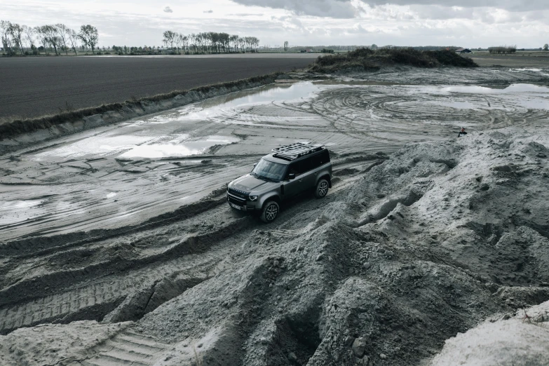 a pick up truck traveling on muddy road