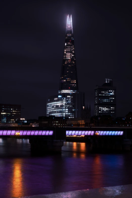 a skyline at night with lights on and a city in the background