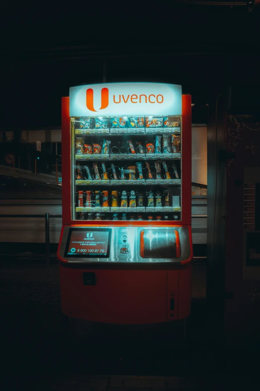 an orange soda machine with drinks in it's display