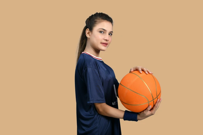 a woman is holding a ball and posing for a po