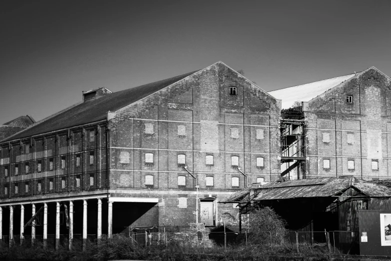 the front of an old brick building with a tower