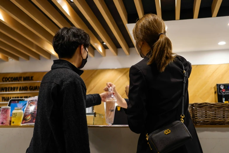 man and woman at the counter of a business