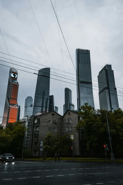 large skyscrs standing on a corner in the middle of a city