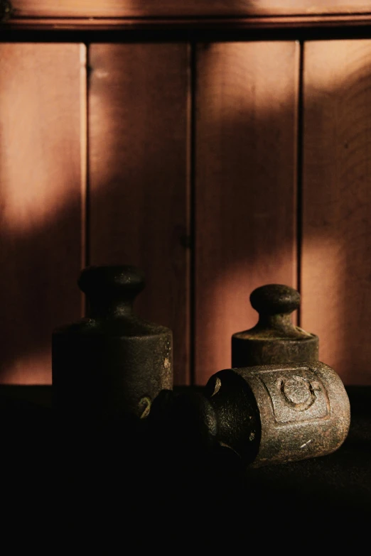 an old urn in front of a wooden wall