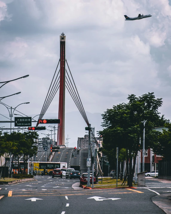 a airplane flies above the city street at an intersection