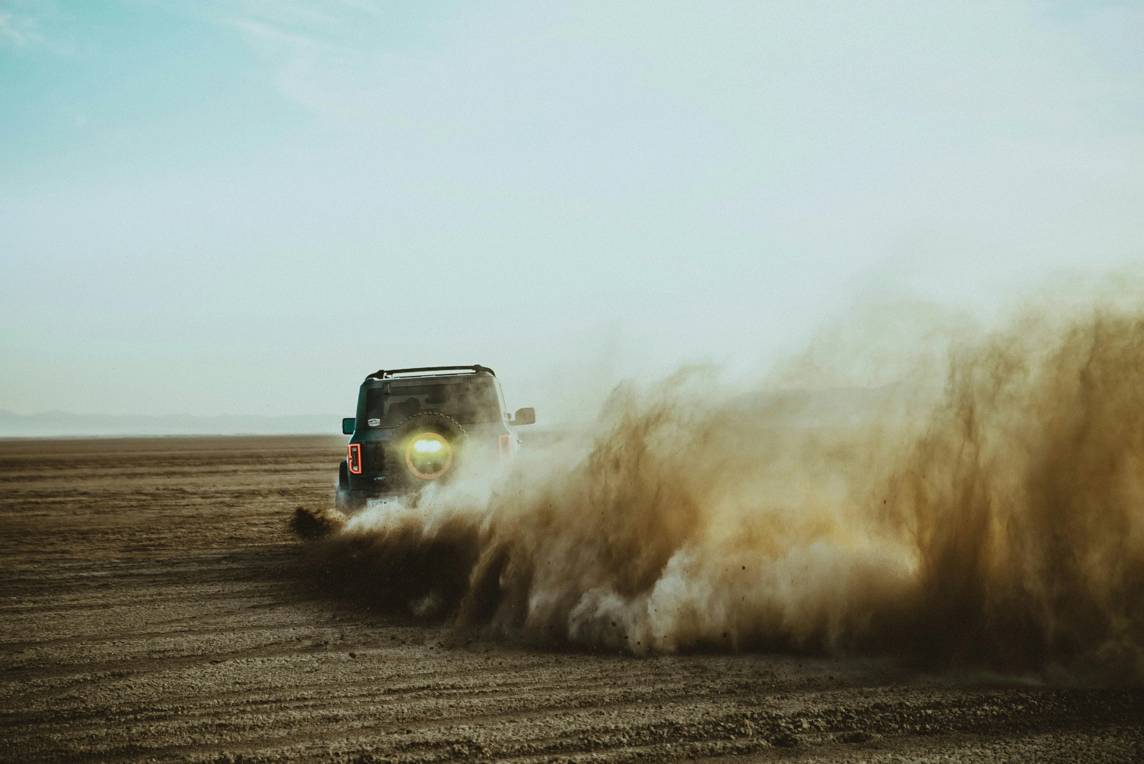 the vehicle is driving across the open field