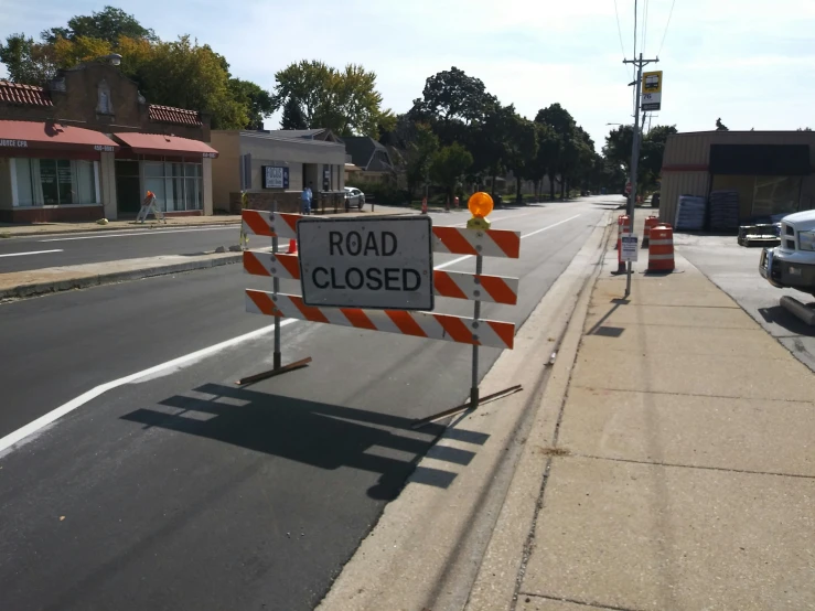 some construction signs are near the road closed