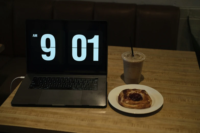 a cup of coffee sitting next to a laptop