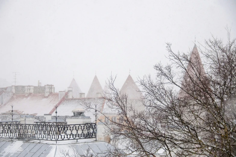 the view from a rooftop of a snowy city