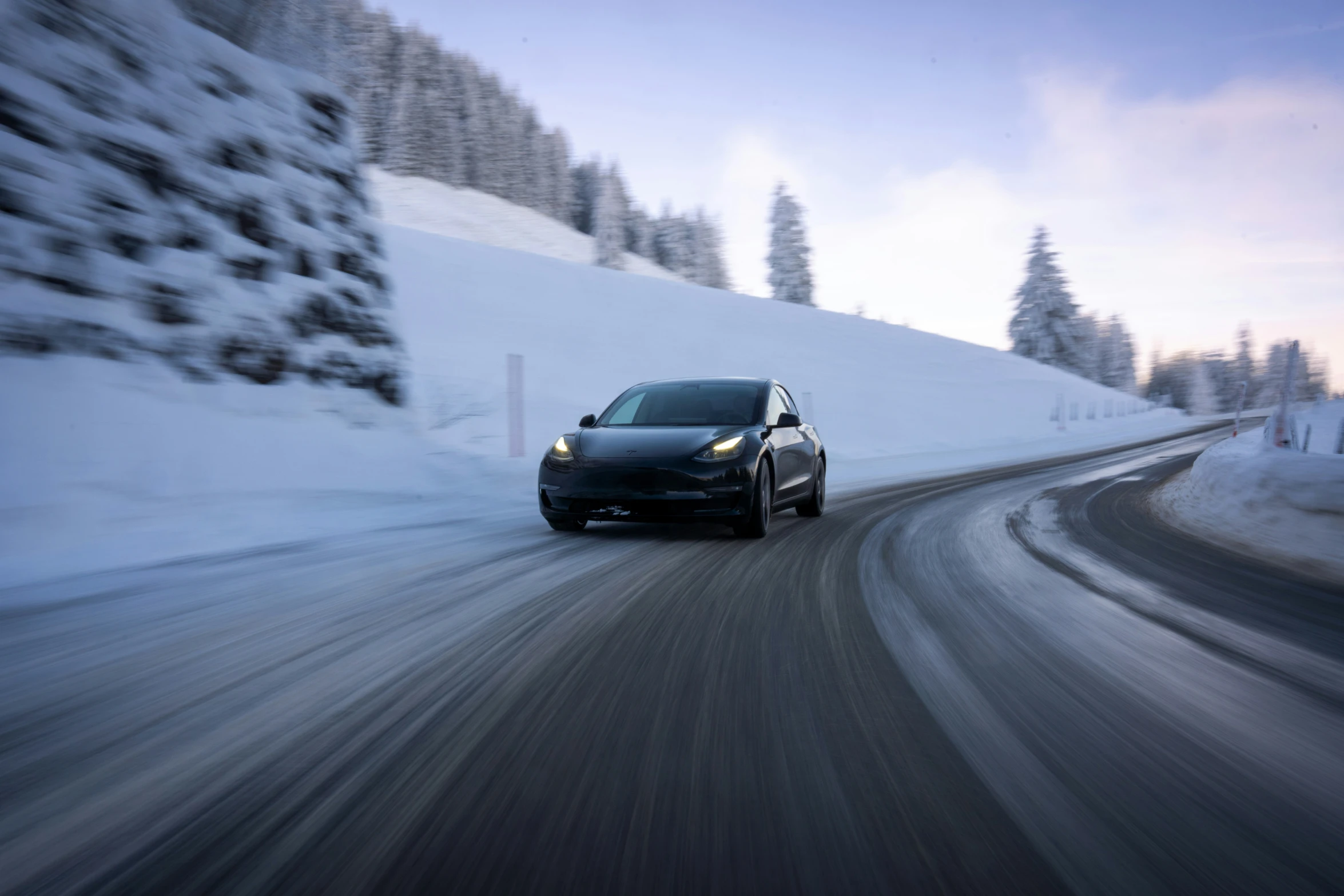 a car is driving in front of some snow