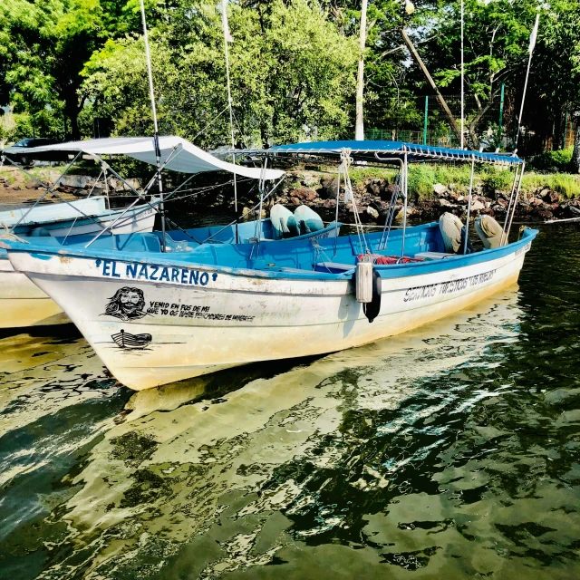 two small boats floating on top of the water