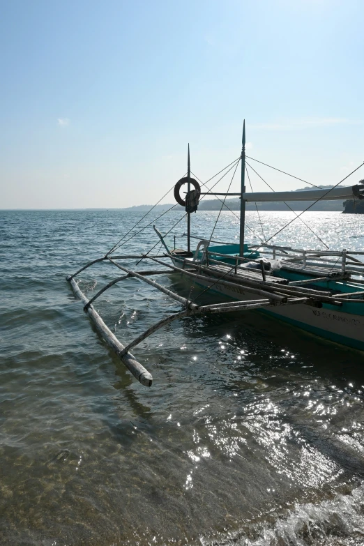 a boat in a body of water with a metal object in the foreground