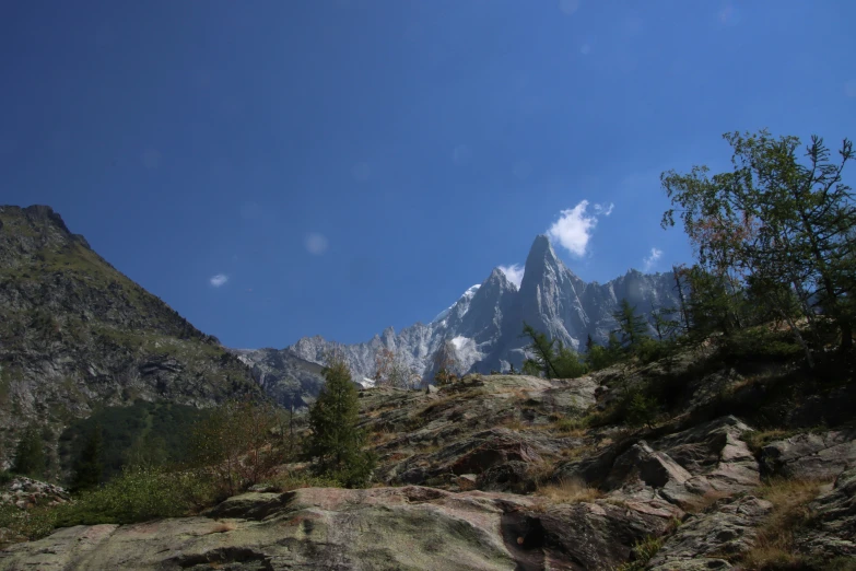 the mountains on a clear day with a few clouds