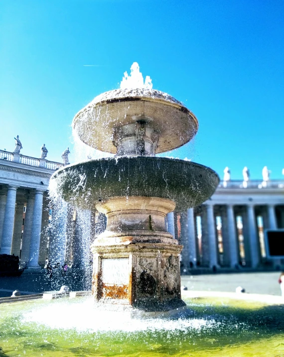 the fountain has water spilling from it