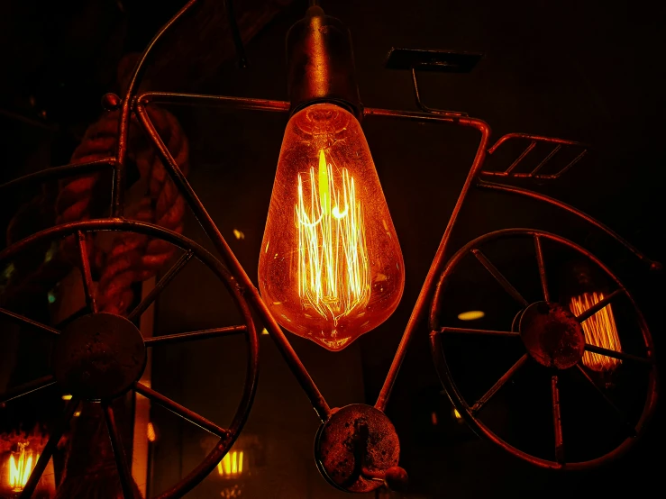 an old fashioned light is lit on a bike in the dark