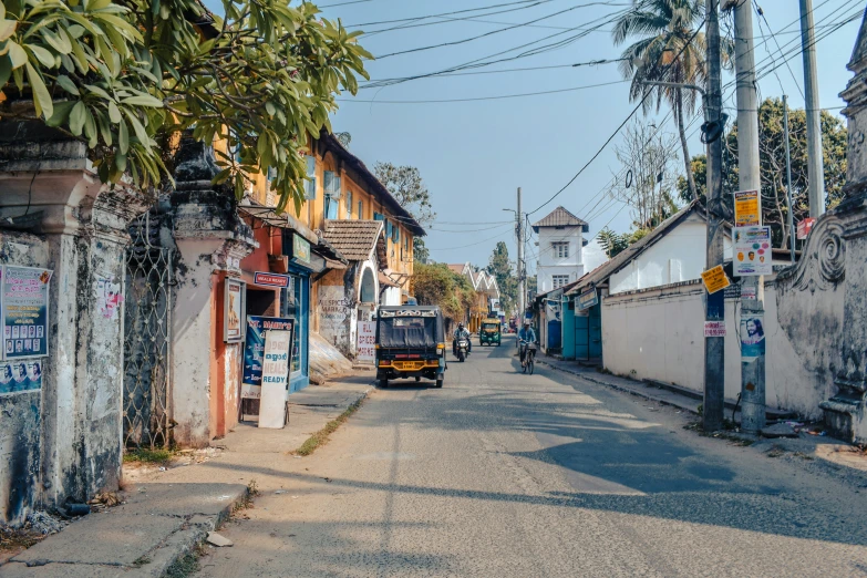 an empty street that has houses and telephone wires