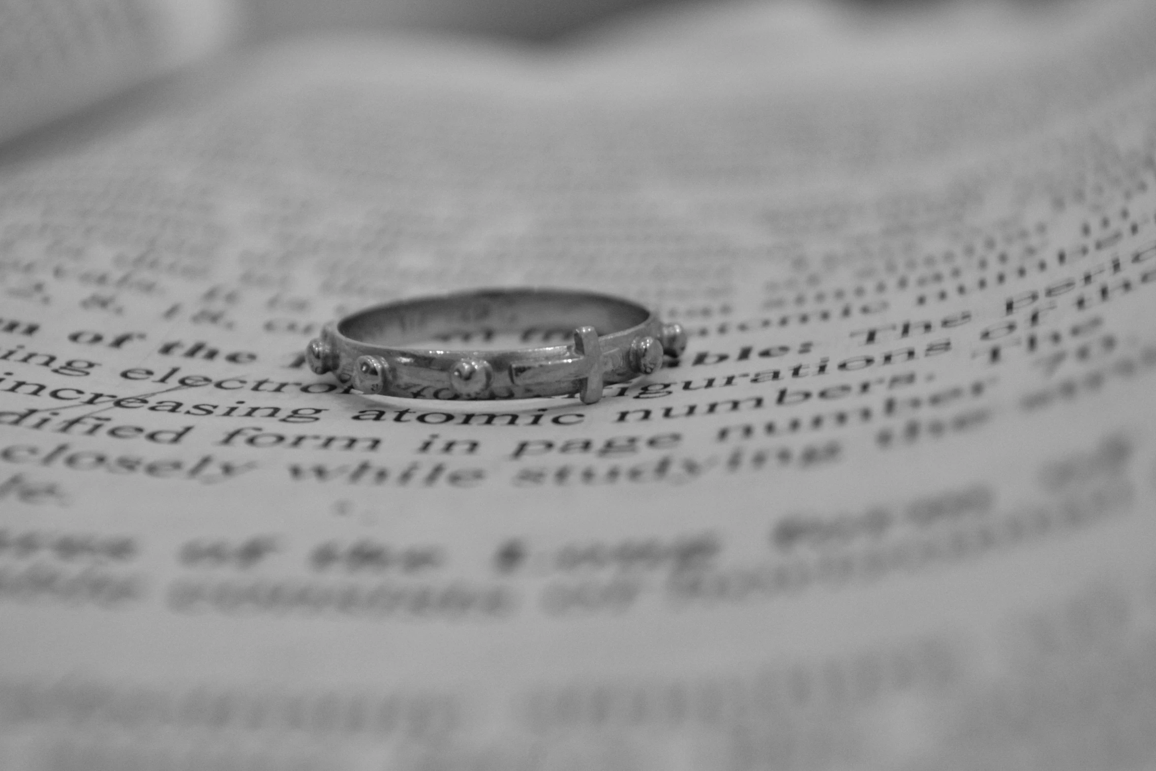 a ring sitting on top of a book that is open