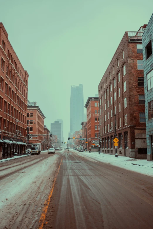 a city street is empty with snow and ice