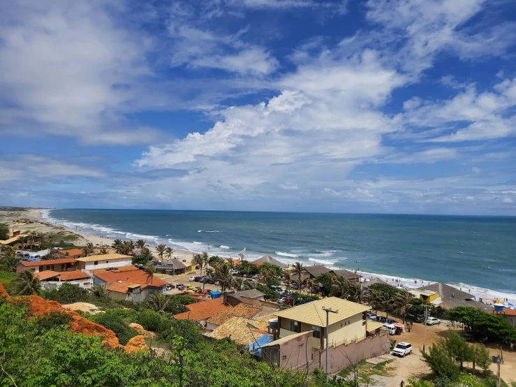 the beach is full of surf and houses