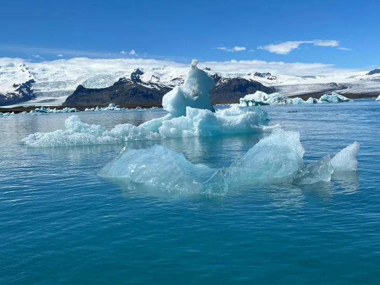 a blue water and snow covered mountain range