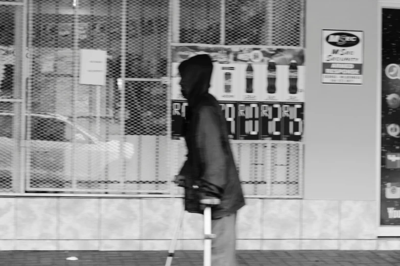 a man is standing with a stick on the street