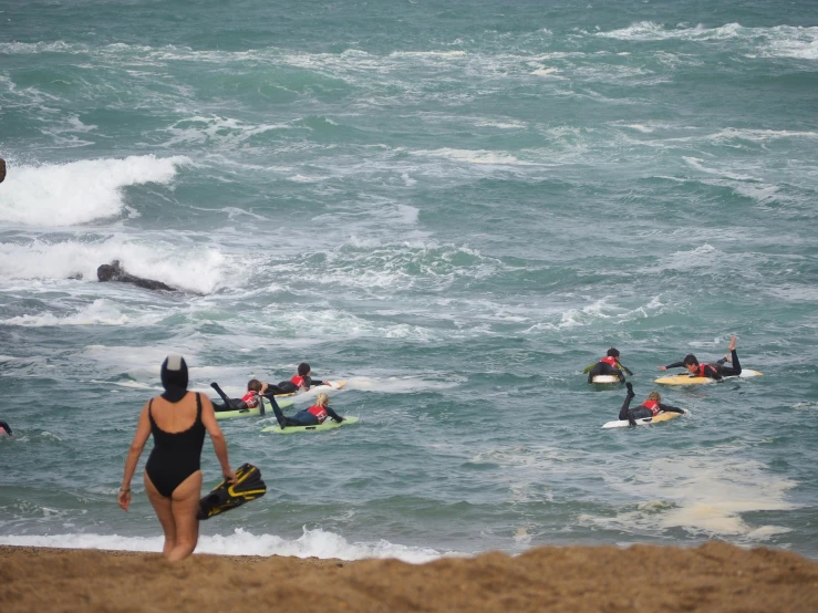 surfers are paddling their surfboards into the waves