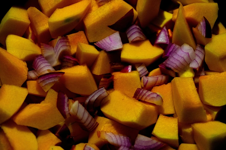 a pile of yellow and red diced vegetables