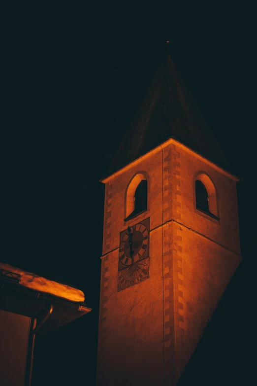 an old clock tower in a dark sky