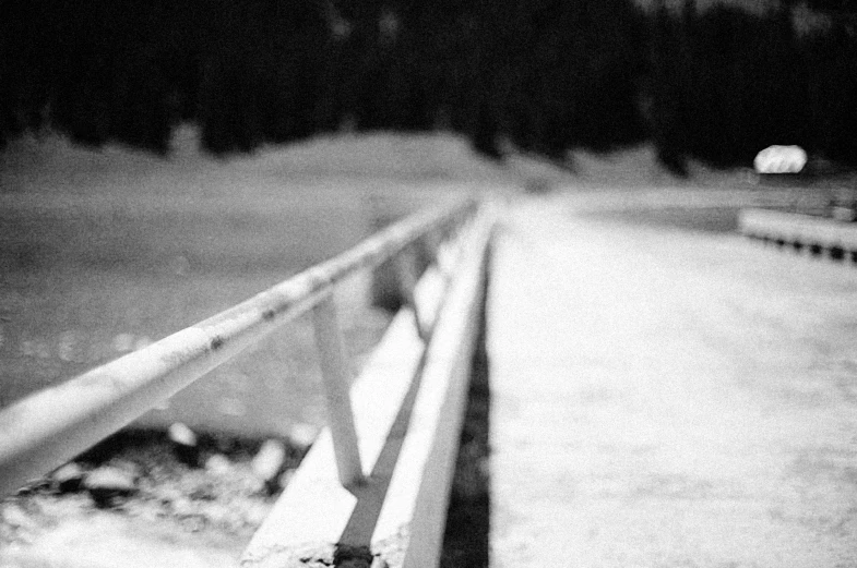 two wooden benches sitting along a dark road