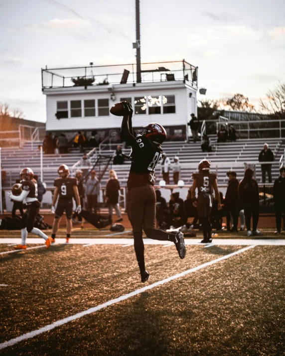 a football player jumping up to catch the ball