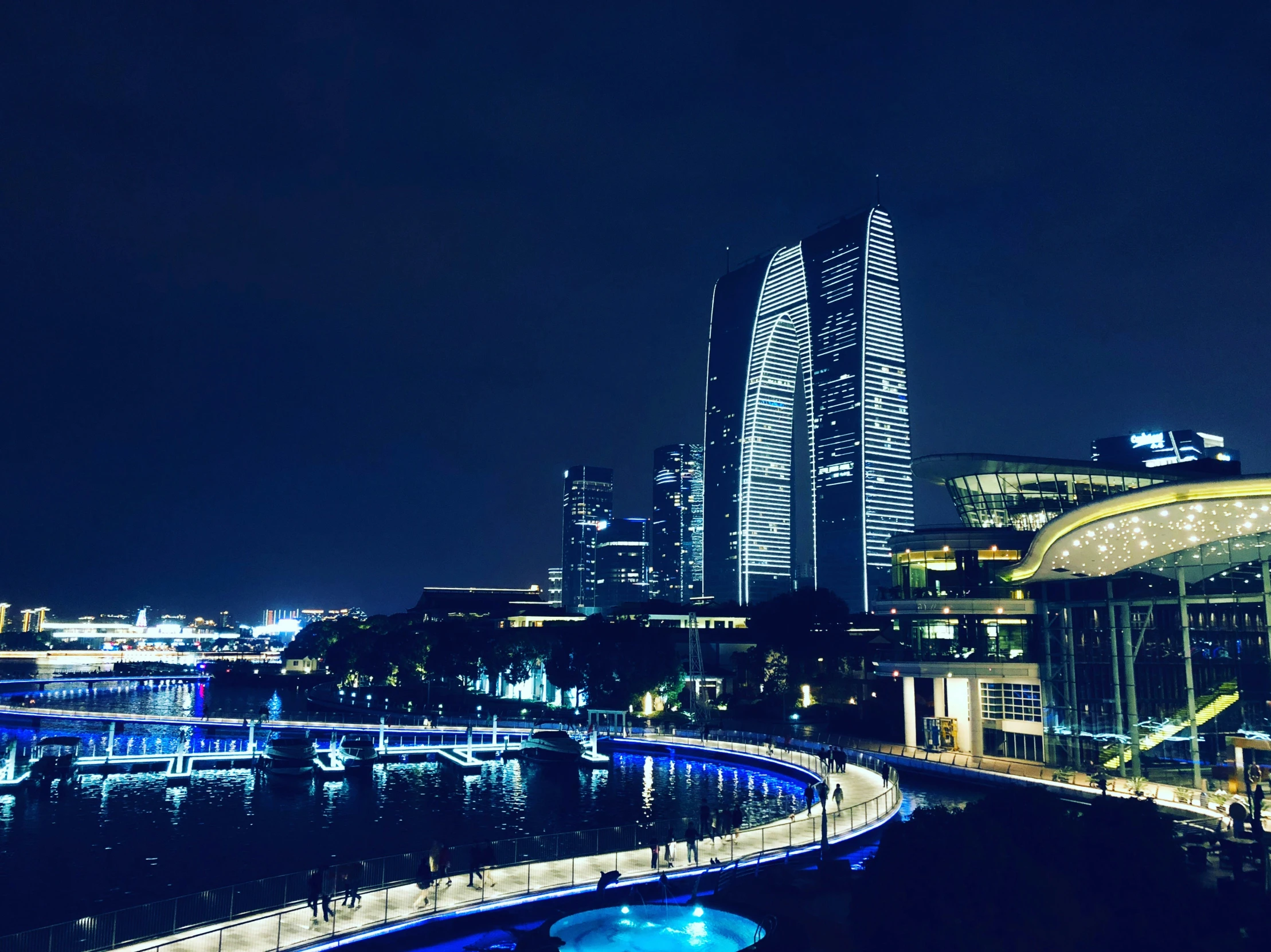 a big city at night with a long bridge