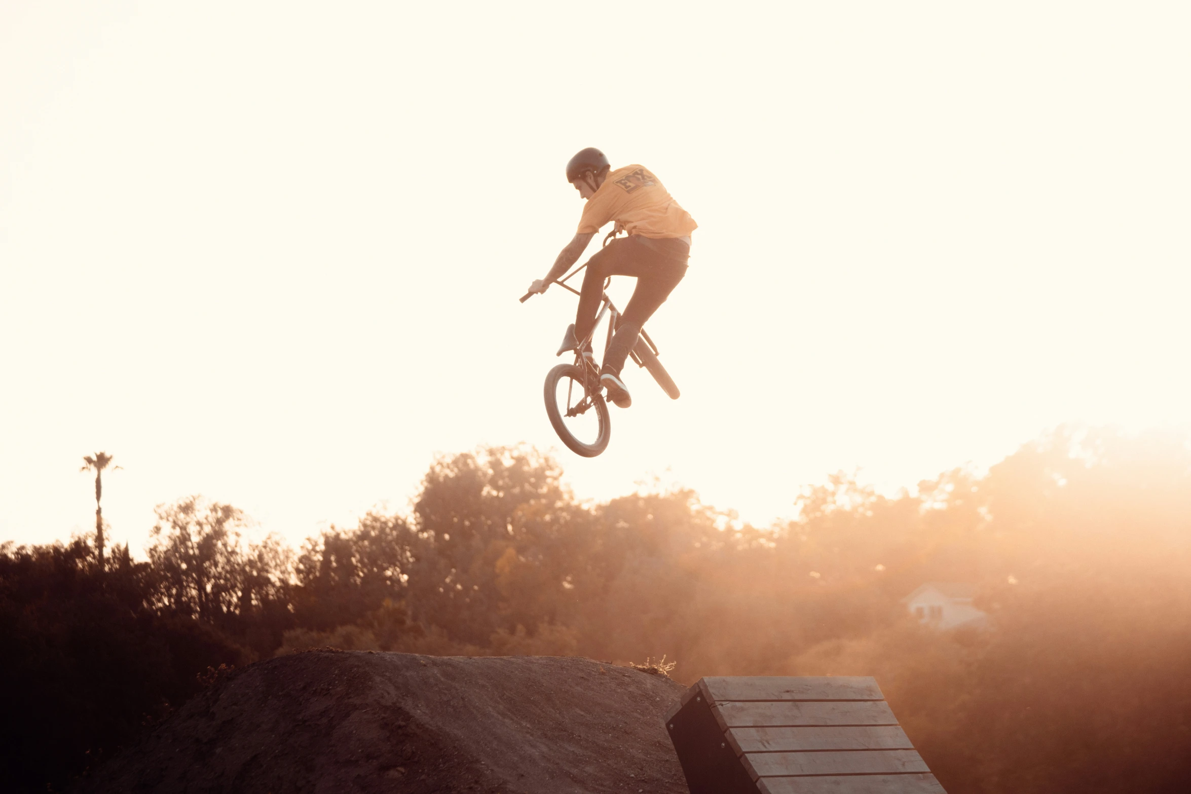 the young man is in mid air with his bike on