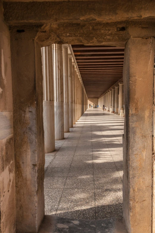 a view of a street that has many columns lining it