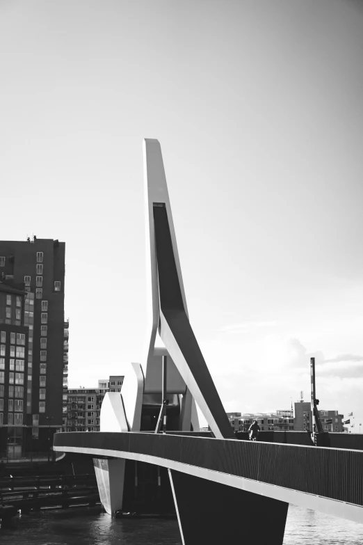 a bridge over water with buildings in the background