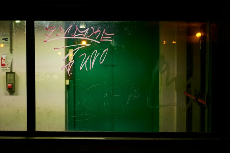 a green door is shown in a dark room