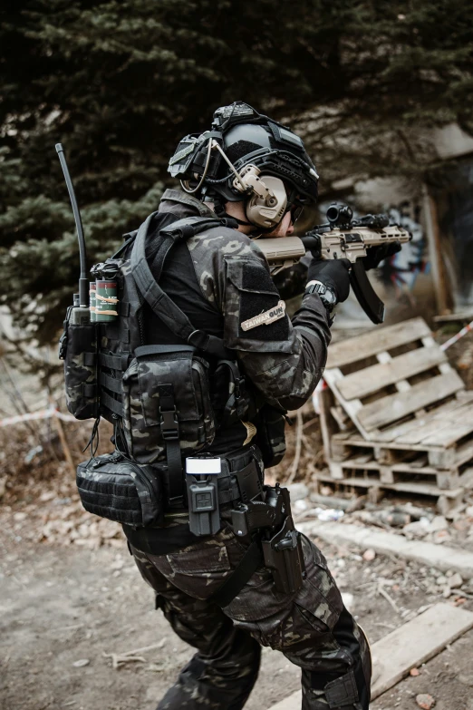 a soldier holding a rifle in the woods