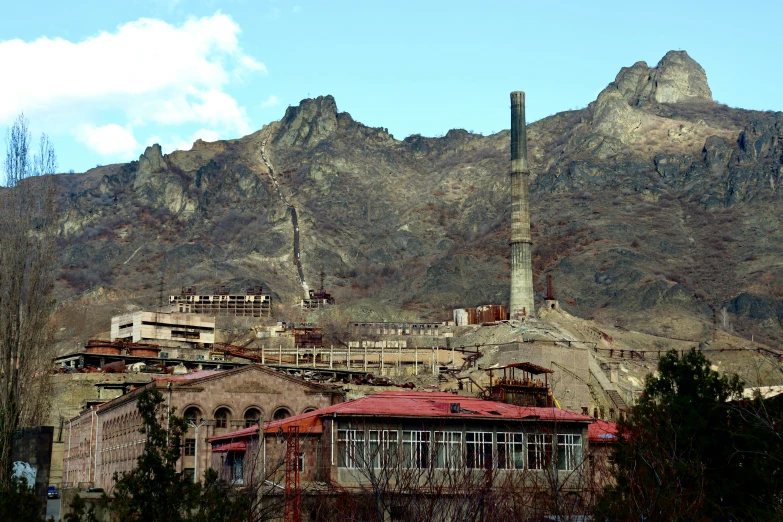 a picture of a factory and a large mountain