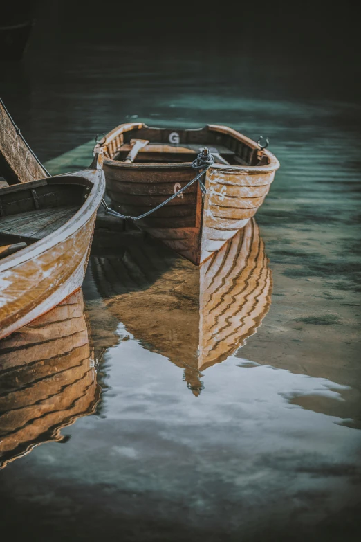 a boat on the water, with a reflection in the water