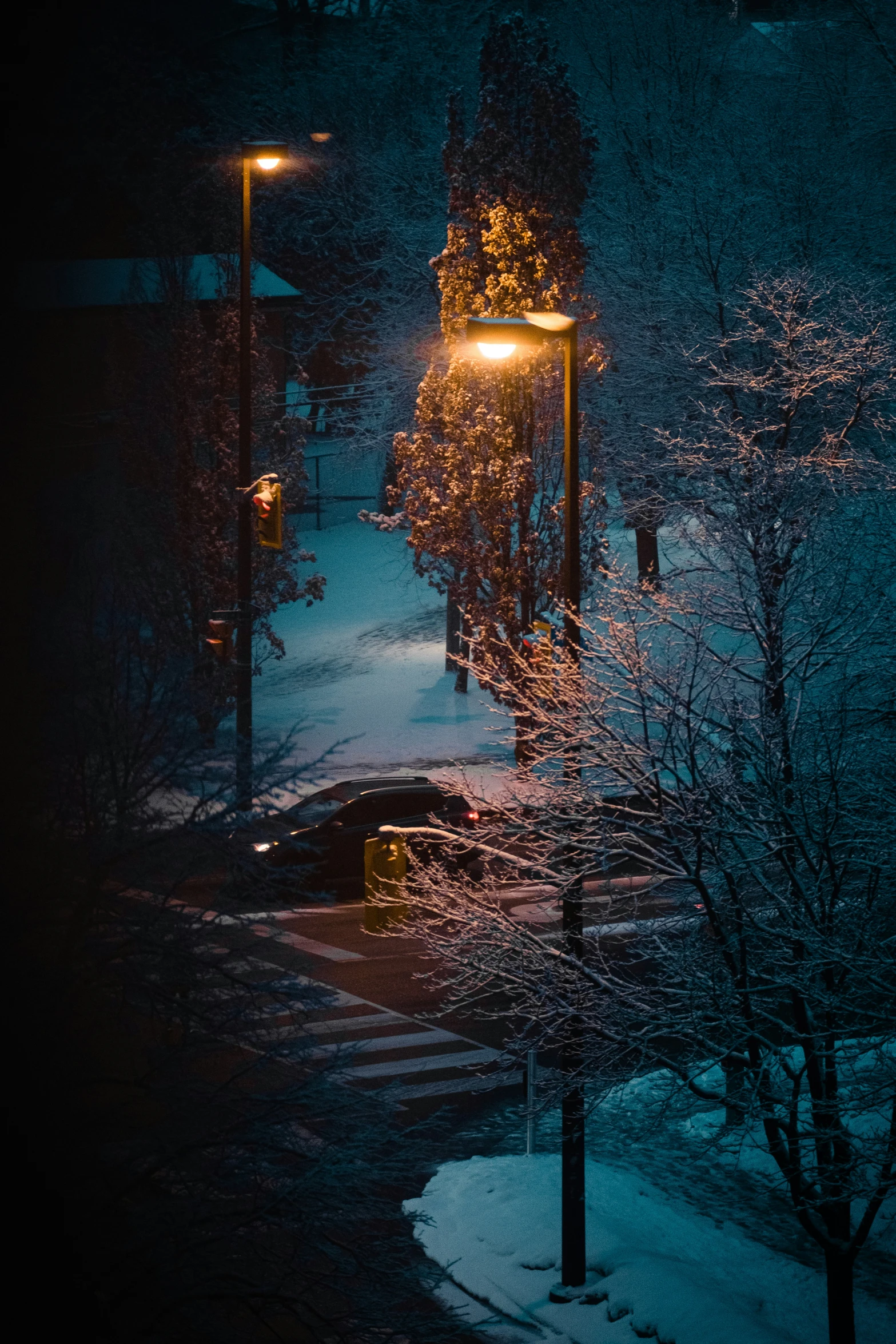 a car driving at night on a road covered with snow