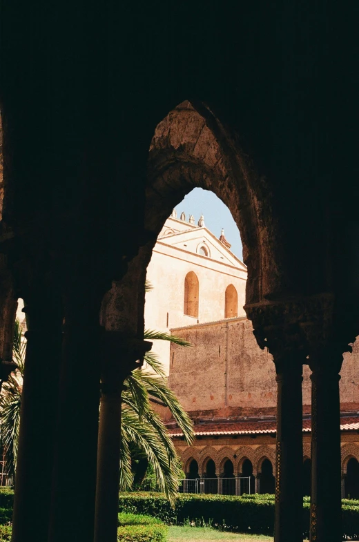 an old building with arches and trees