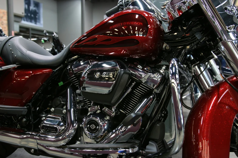 a shiny red motorcycle parked in a showroom