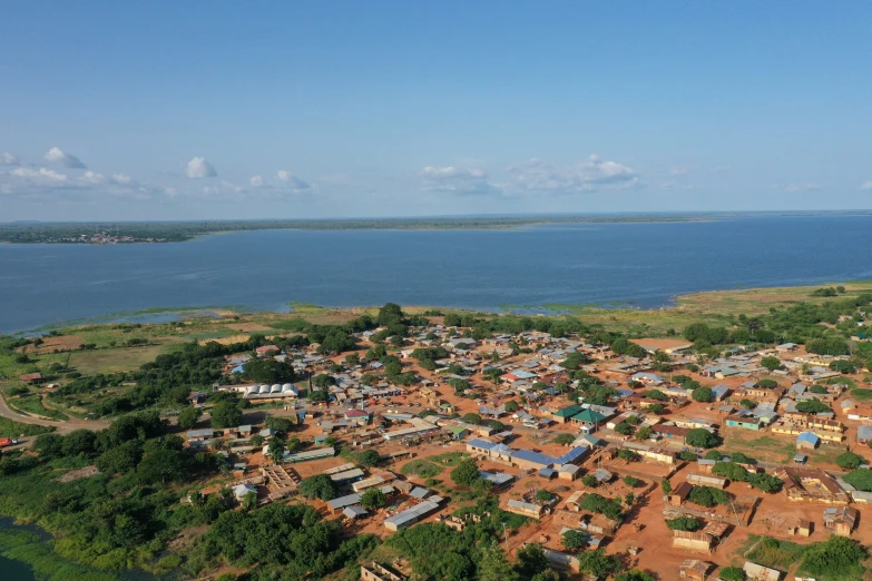 a aerial view of a village beside a lake