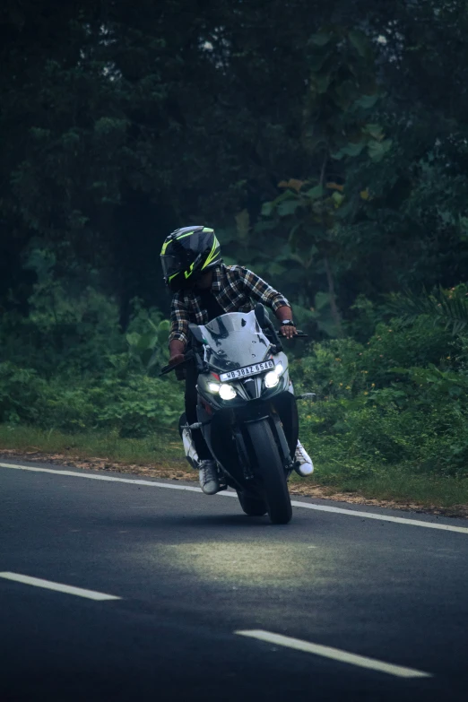 man on motorcycle in the middle of the road