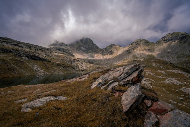 a very high mountain covered in lots of brown grass